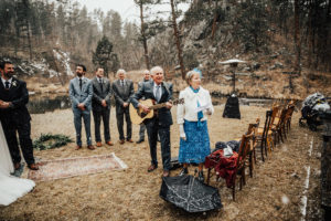 grooms parents sing mid ceremony for bride, groom and guests